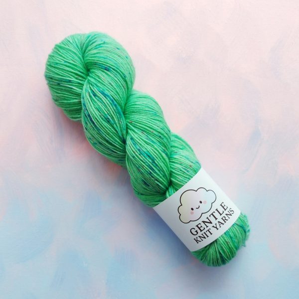 hand dyed 4ply yarn pastel green with pink and blue speckles called spring meadow