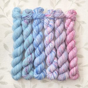 hand dyed 4 ply set of 6 x 20g mini skeins in shades of blue and pink with speckles called Blue Pink Speckle.