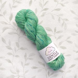 hand dyed yarn 4 ply 100g in shades of green with pink and blue subtle speckles.