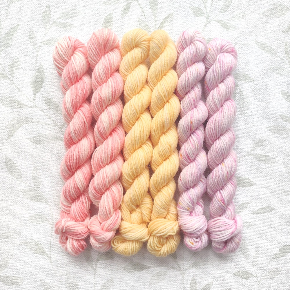 hand dyed 4 ply 6 x 20g skein set in shades of pink, peach and lemon called Citrus Blossom.