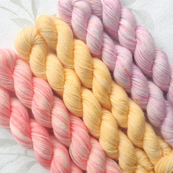 hand dyed 4 ply 6 x 20g skein set in shades of pink, peach and lemon called Citrus Blossom.