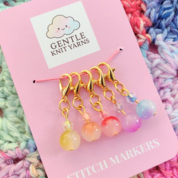 photo of 5 rainbow glass bead stitch markers which are a free gift in the DK Yarn Mystery Bundle Gift Box.